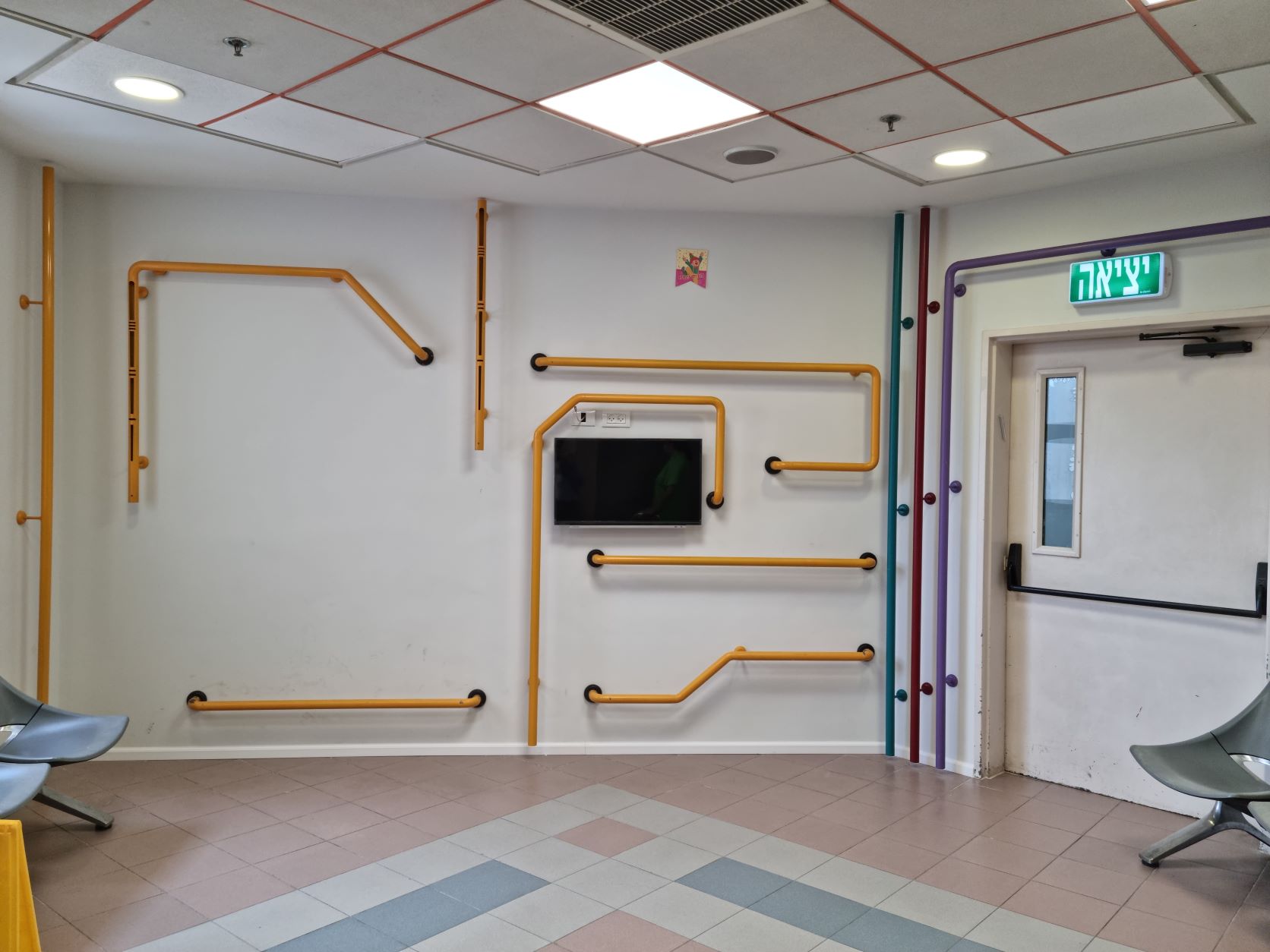 צינורות מתכת צבעוניים המשמשים מתקן לתרגול ותנועה במרחב לטובת מטופלים המתניידים עצמאית או בכיסא גלגלים
